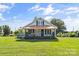 Charming home featuring a covered front porch with an American flag, perfect for relaxing and enjoying the outdoors at 35 Telephone Exchange Rd, Hickory, NC 28601