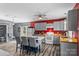 Eat-in kitchen with gray cabinets, red accent wall, wood countertops, stainless appliances, and island seating at 35 Telephone Exchange Rd, Hickory, NC 28601