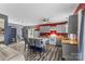 Eat-in kitchen with gray cabinets, red accent wall, wood countertops, stainless appliances, and island seating at 35 Telephone Exchange Rd, Hickory, NC 28601