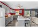 Bright eat-in kitchen with gray cabinets, red accent wall, wood countertops and stainless appliances at 35 Telephone Exchange Rd, Hickory, NC 28601