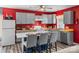 Bright eat-in kitchen with gray cabinets, red accent wall, wood countertops and stainless appliances at 35 Telephone Exchange Rd, Hickory, NC 28601