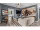Open living room featuring stylish gray walls, wood floors, ceiling fan and large train art piece at 35 Telephone Exchange Rd, Hickory, NC 28601