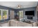 Cozy living room featuring gray walls, wood floors, front window and a comfortable couch at 35 Telephone Exchange Rd, Hickory, NC 28601