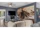 Stylish living room featuring gray walls, wood floors, ceiling fan and large train art piece at 35 Telephone Exchange Rd, Hickory, NC 28601