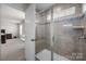 Tiled shower with glass door and built-in bench, adjacent to the bedroom space at 3643 Slider Ter, Lancaster, SC 29720