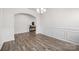 An empty dining room featuring hard wood floors, an archway, chair rail, and elegant chandelier at 3643 Slider Ter, Lancaster, SC 29720