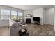 Bright living room featuring a fireplace, wood flooring, and an oversized sofa at 3643 Slider Ter, Lancaster, SC 29720