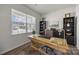 Cozy home office with a wooden desk, shelves, and a large window at 3643 Slider Ter, Lancaster, SC 29720