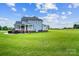 Home backyard with a lush green lawn and mature trees creating a private and serene atmosphere at 3707 Seagrave Farm Rd, Concord, NC 28025