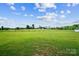 Backyard with lush green grass surrounded by wooden fence at 3707 Seagrave Farm Rd, Concord, NC 28025