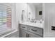 Well-lit bathroom featuring a marble countertop vanity, white cabinets, and modern fixtures at 3707 Seagrave Farm Rd, Concord, NC 28025