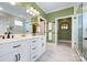 Spacious bathroom featuring a double vanity with a marble countertop and large mirrors at 3707 Seagrave Farm Rd, Concord, NC 28025