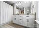 Elegant bathroom featuring double sinks with granite countertops and bright lighting at 3707 Seagrave Farm Rd, Concord, NC 28025