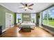 Spacious bedroom with hardwood floors, green walls, and bright natural light from multiple windows at 3707 Seagrave Farm Rd, Concord, NC 28025