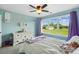 Bright bedroom with a large window offering scenic views, soft carpet, and a cozy white bed at 3707 Seagrave Farm Rd, Concord, NC 28025
