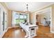 Bright dining room with large windows, hardwood floors, and a neutral color palette at 3707 Seagrave Farm Rd, Concord, NC 28025