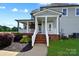 Charming home featuring a covered porch, brick accents, and well-manicured landscaping at 3707 Seagrave Farm Rd, Concord, NC 28025