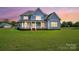Beautiful two-story home with a covered front porch and expansive lawn creating a welcoming curb appeal at 3707 Seagrave Farm Rd, Concord, NC 28025