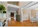 Bright foyer with hardwood floors, an open staircase, and views of the living room and dining room at 3707 Seagrave Farm Rd, Concord, NC 28025