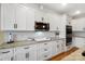 Modern kitchen with white cabinets, marble countertops, stainless steel appliances, and tiled backsplash at 3707 Seagrave Farm Rd, Concord, NC 28025
