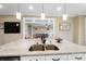 Kitchen island with marble countertops, stainless steel sink, and view of the living room at 3707 Seagrave Farm Rd, Concord, NC 28025