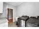 Convenient laundry room with modern washer and dryer, utility sink, and neutral decor at 3707 Seagrave Farm Rd, Concord, NC 28025