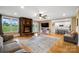 Open-concept living room with fireplace and kitchen view, featuring hardwood floors at 3707 Seagrave Farm Rd, Concord, NC 28025