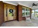 Inviting front porch with rocking chairs, a wood door, and brick accents at 3707 Seagrave Farm Rd, Concord, NC 28025