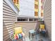 Cozy outdoor balcony featuring comfortable seating with bright pillows and a small table at 415 W 7Th St # F, Charlotte, NC 28202