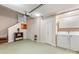Basement laundry area with washer, dryer, storage cabinets, and convenient access to the stairs at 415 W 7Th St # F, Charlotte, NC 28202