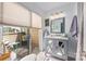 Bright bathroom with a vanity, mirror, and access to a private balcony with seating at 415 W 7Th St # F, Charlotte, NC 28202