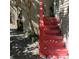 Welcoming red staircase leading to the front door with charming landscaping at 415 W 7Th St # F, Charlotte, NC 28202