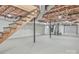 Unfinished basement with open ceiling, stairs, and concrete flooring offers potential for customization at 4566 Fork Rd, Norwood, NC 28128
