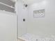 Modern bathroom features an open shower with white tile surround and a recessed niche at 4566 Fork Rd, Norwood, NC 28128