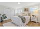 Cozy bedroom features a comfortable bed, soft lighting, and ample natural light from two large windows at 4566 Fork Rd, Norwood, NC 28128