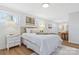 Bright bedroom features a queen bed, warm lamps, natural light and art decorations at 4566 Fork Rd, Norwood, NC 28128