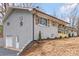 Charming brick house with a light grey exterior, wooden shutters, and manicured front lawn at 4566 Fork Rd, Norwood, NC 28128
