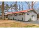 Side view of brick home with a red roof, new landscaping, and private entrance at 4566 Fork Rd, Norwood, NC 28128