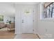 Bright foyer with a clear view to the living room and newly finished hardwood flooring at 4566 Fork Rd, Norwood, NC 28128