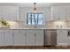 Well-lit kitchen features stainless steel dishwasher, modern faucet, and white cabinets with quartz countertops at 4566 Fork Rd, Norwood, NC 28128