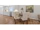 Eat-in kitchen with white cabinets, tile backsplash, and hardwood floors at 4566 Fork Rd, Norwood, NC 28128