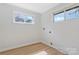 Room with hardwood floors, two windows, electrical outlets, and in-wall hookups for washer and dryer at 4566 Fork Rd, Norwood, NC 28128