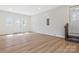 Large, open space with hardwood floors, a double door entry, and natural light from multiple windows at 4566 Fork Rd, Norwood, NC 28128