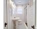 Bathroom featuring white subway tile, black and white floor tiles, and updated fixtures at 501 Pee Dee Ave, Albemarle, NC 28001
