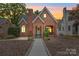 Charming brick home featuring a cozy front porch and well-manicured landscaping at 501 Pee Dee Ave, Albemarle, NC 28001