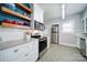 Bright kitchen featuring stainless steel appliances, granite counters, and wooden floating shelves at 501 Pee Dee Ave, Albemarle, NC 28001