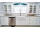 Kitchen featuring a farmhouse sink, granite countertops, stainless steel appliances, and white cabinetry at 501 Pee Dee Ave, Albemarle, NC 28001