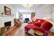 Inviting living room with a brick fireplace, hardwood floors, and built-in bookshelves at 501 Pee Dee Ave, Albemarle, NC 28001