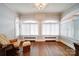 Bright sitting area with large windows and original hardwood floors at 501 Pee Dee Ave, Albemarle, NC 28001