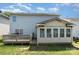 Sunny backyard featuring a deck, sunroom, and lush green space, ideal for outdoor enjoyment at 5141 Grays Ridge Dr, Charlotte, NC 28269